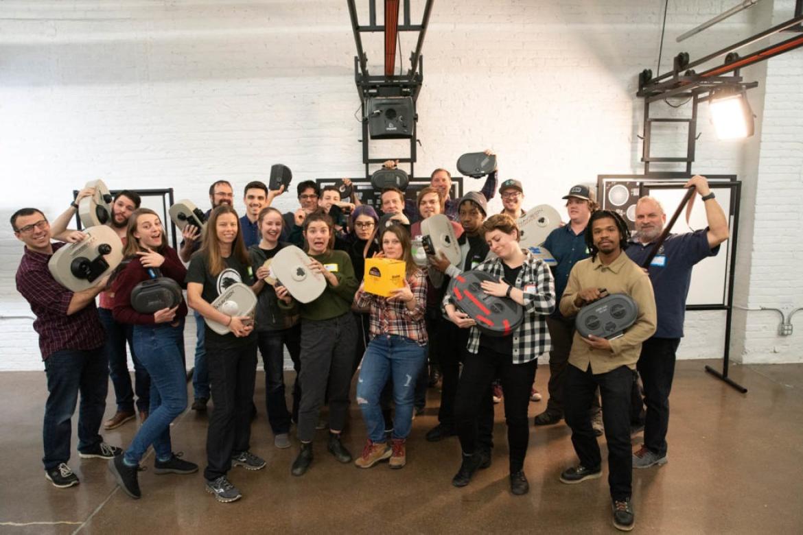 Group of people pose for a photo holding film loaders