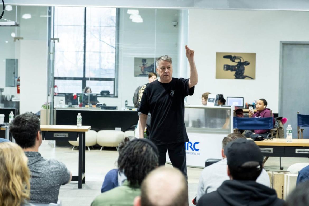 Man speaks in front of a class