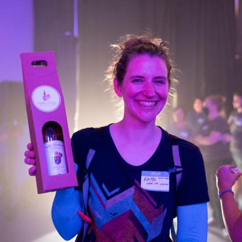 Woman posing with bottle of wine. 