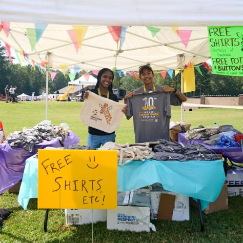 People posing with free shirts. 