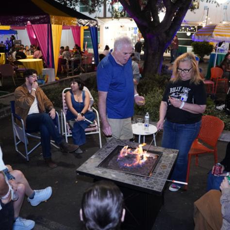 People by a table fire. 