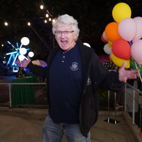 Person posing for photo with excited look. 