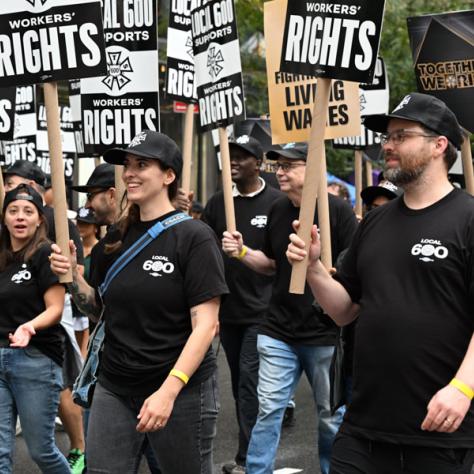People marching in Labor Day parade.