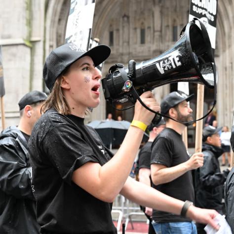 Woman speaking into megaphone. 