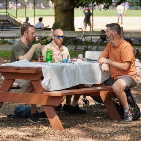 People on a picnic table. 
