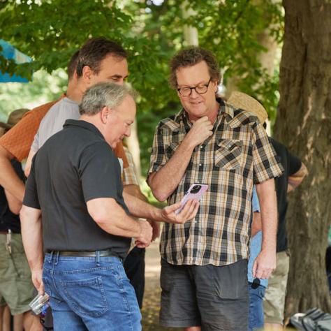 People looking at a phone. 