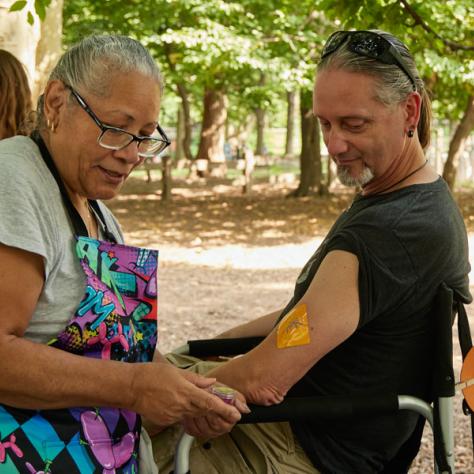 Man getting arm painted. 