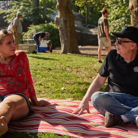 Two people on a picnic blanket. 