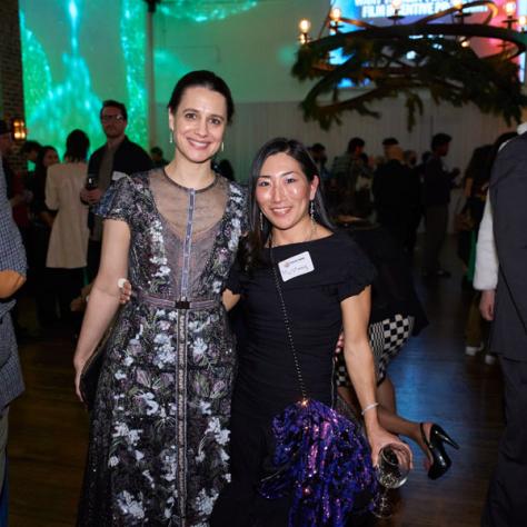 Two women posing for photo. 