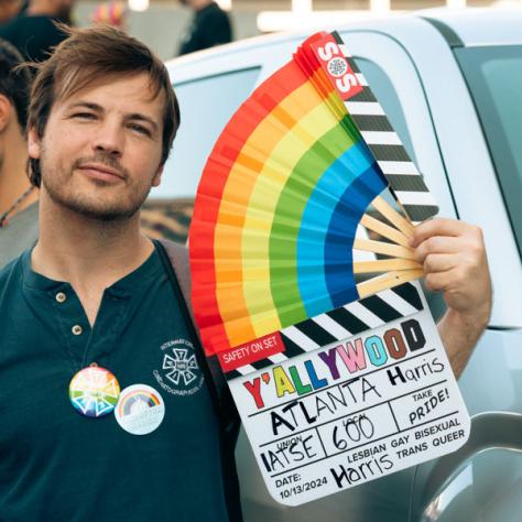 Man posing for photo at parade. 