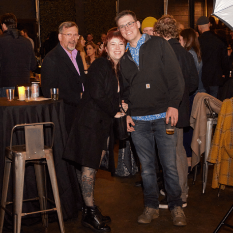 People posing for photo together. 