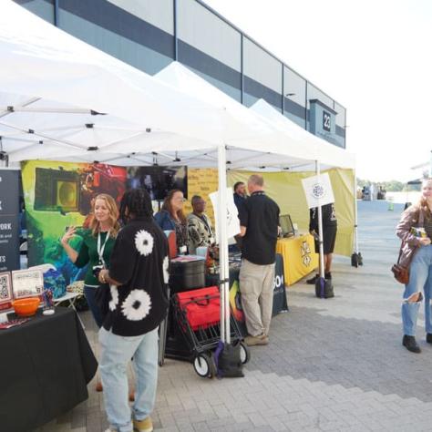 People walking around vendor booths. 