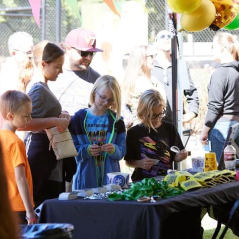 Kids making things at booth. 