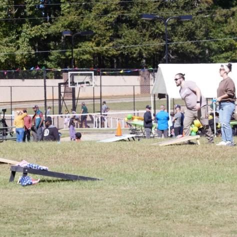 People playing cornhole outside. 