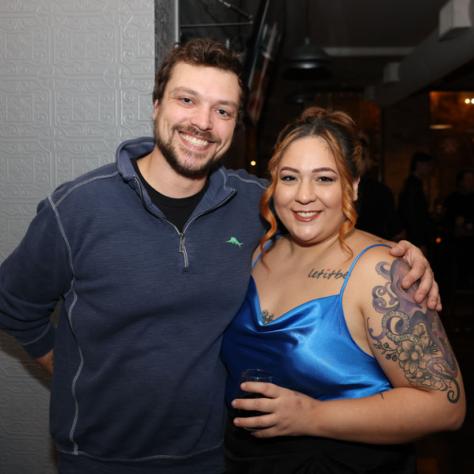 People posing for photo at party.