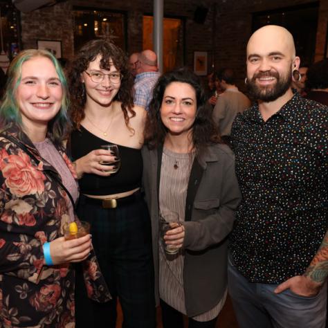 People posing for photo at party.