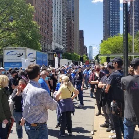 People standing outside at a rally. 