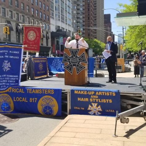 Stage at a rally with man at podium. 