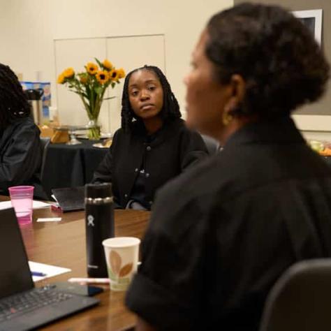 Women sitting at a table. 