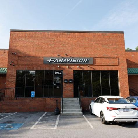 Outside view of store and cars in parking lot. 