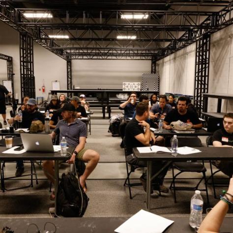 View of entire audience sitting at tables. 