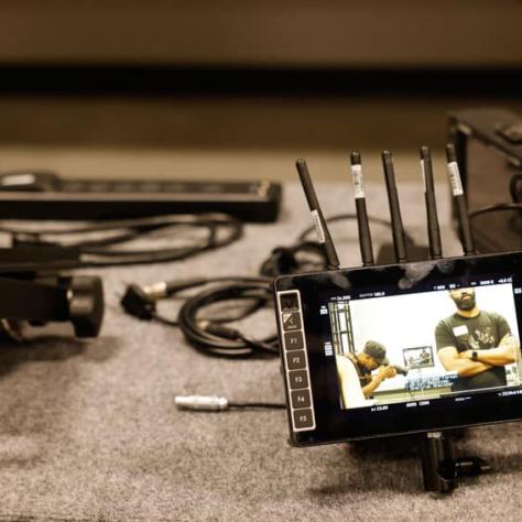 Camera gear sitting on a table. 