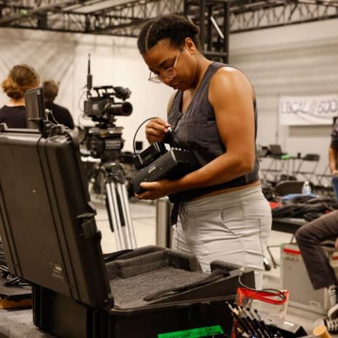 Woman looking at gear. 