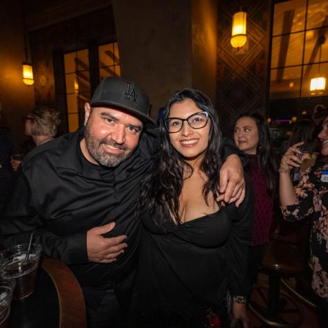 People posing for photo at party.