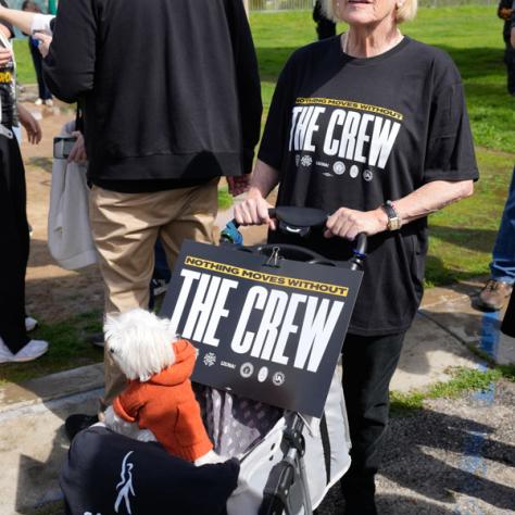People posing for photo with signs.