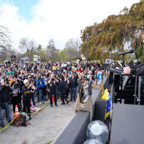 Man speaking to rally crowd. 