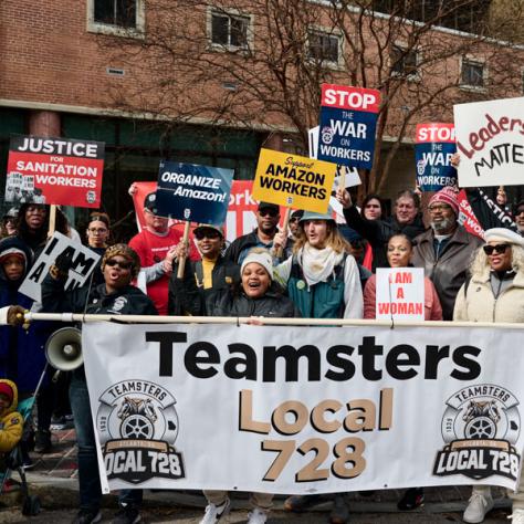 People marching with teamsters sign. 