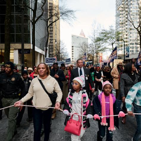 People marching at event. 