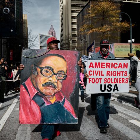 People marching with signs at event.