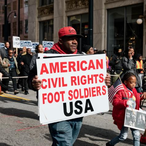 People marching with signs at event.