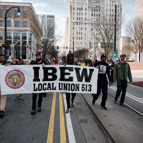 People marching with signs at event.