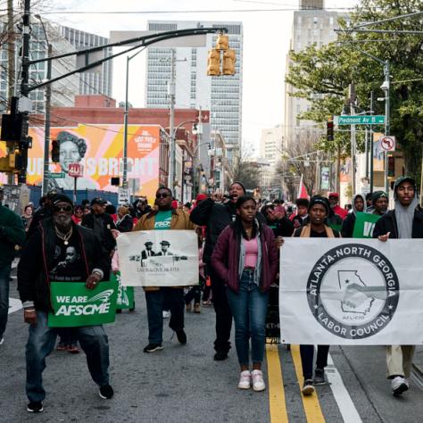 People marching with signs at event.