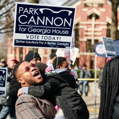 People marching with signs at event.