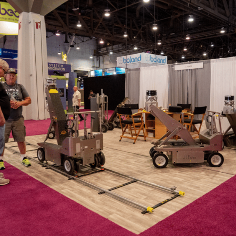 Showroom with small carts and people looking. 