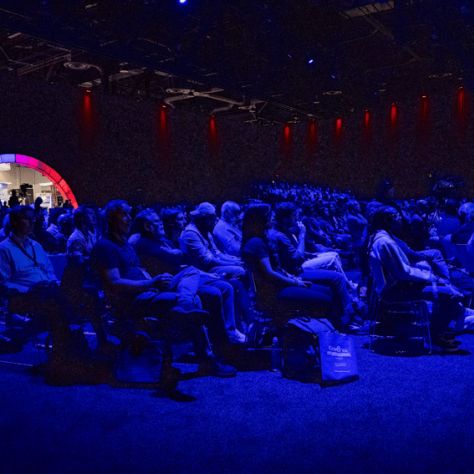Audience members under blue lights. 