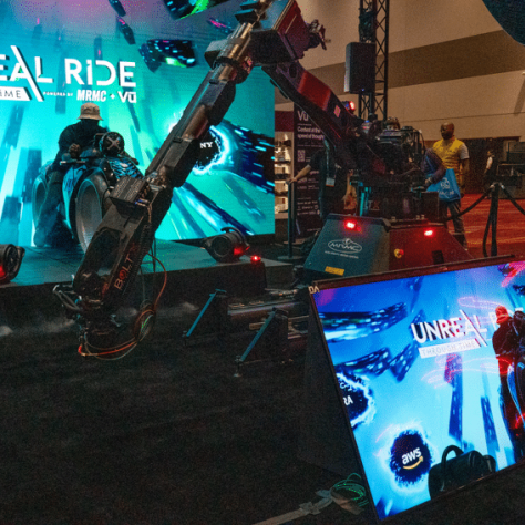 Camera equipment in front of backdrop and view of camera screen. 