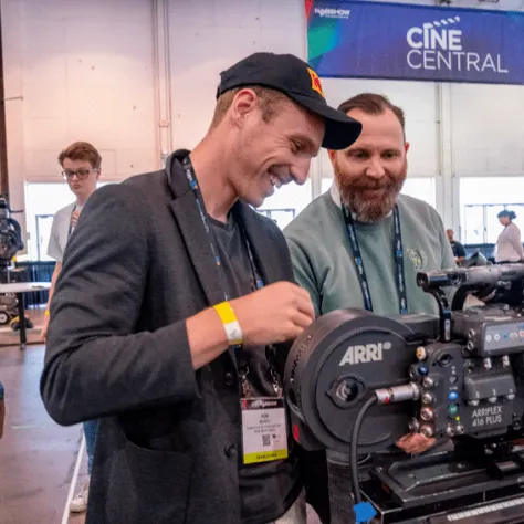 Men smiling looking at a camera. 