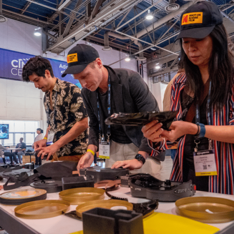 People standing working with film at a table. 