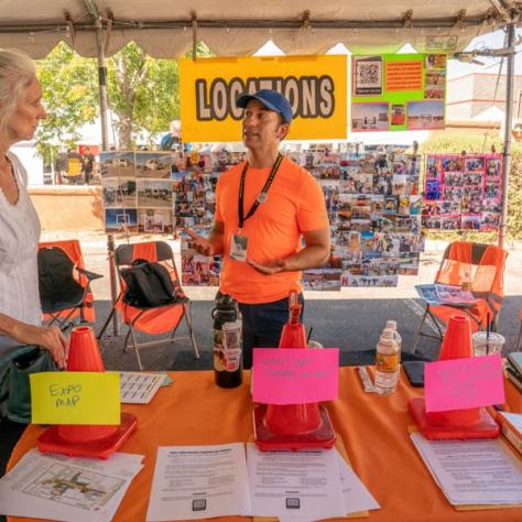 People working at tent booth. 