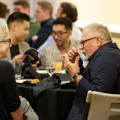 People sitting at table talking. 