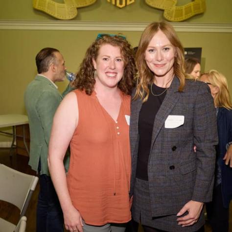 Two women posing for photo. 