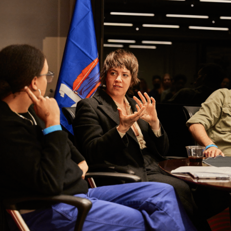 Three people sitting and talking. 