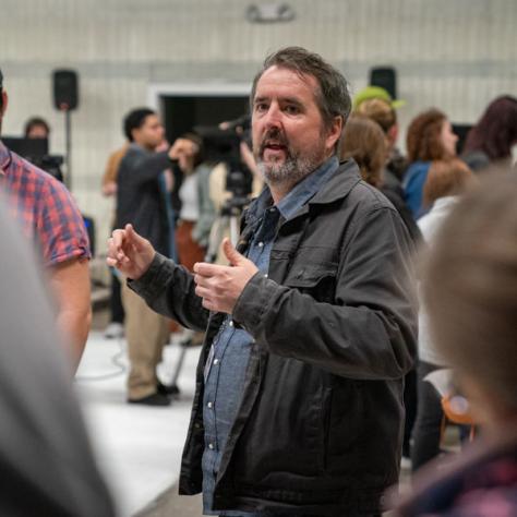 Man speaking to people. 