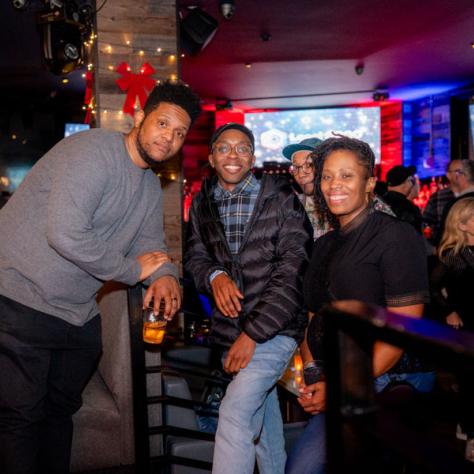 People posing for photo at party.