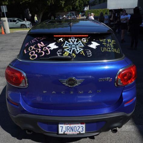 Blue car with decorated window. 