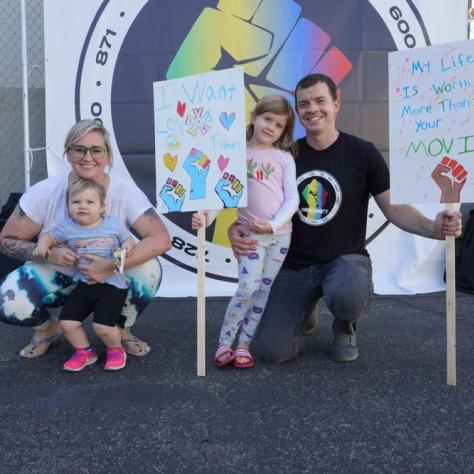 People posing with signs. 